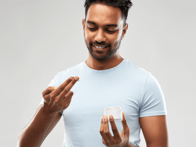 Man applying emollient